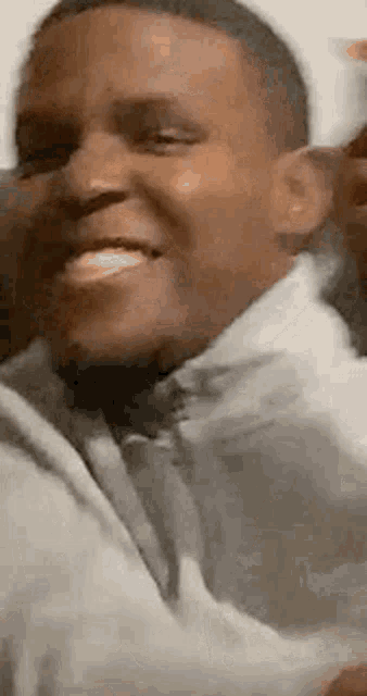 a man in a suit and tie is smiling in a close up .