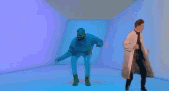 two men are dancing in a room with a blue light .