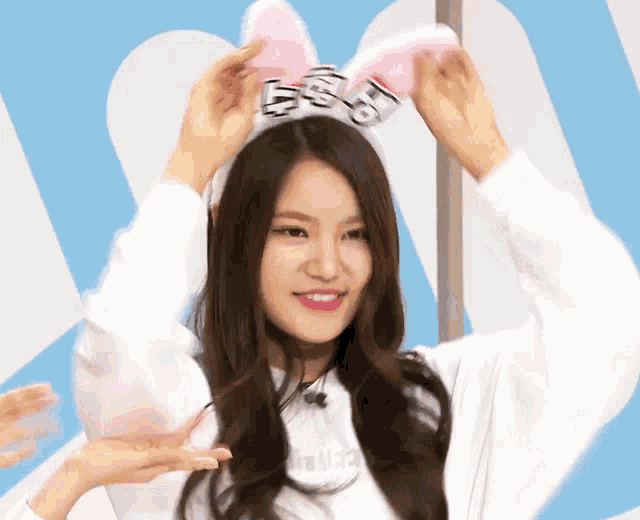 a woman wearing a headband with bunny ears and the letter s on it