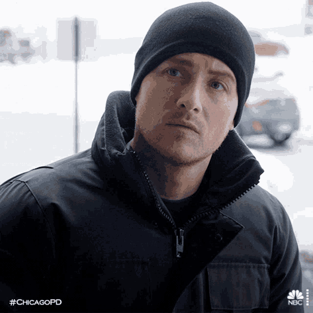 a man wearing a black jacket and a black beanie with the hashtag chicagopd