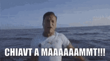 a man in a white shirt stands in the ocean with the words chiavt a maaaa ammt