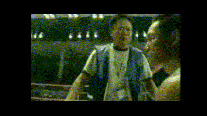 a man without a shirt is standing in a boxing ring