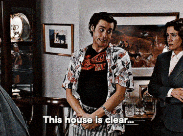 a man wearing a shirt that says ' this house is clear '