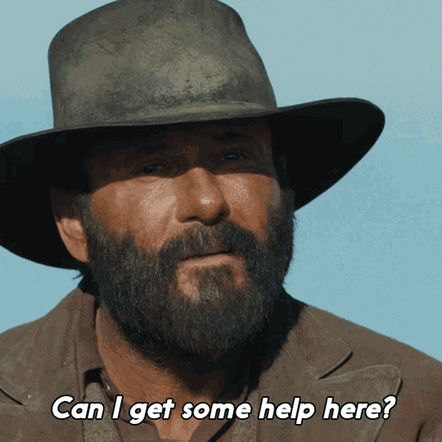 a man with a beard is wearing a hat and asking " can i get some help here "