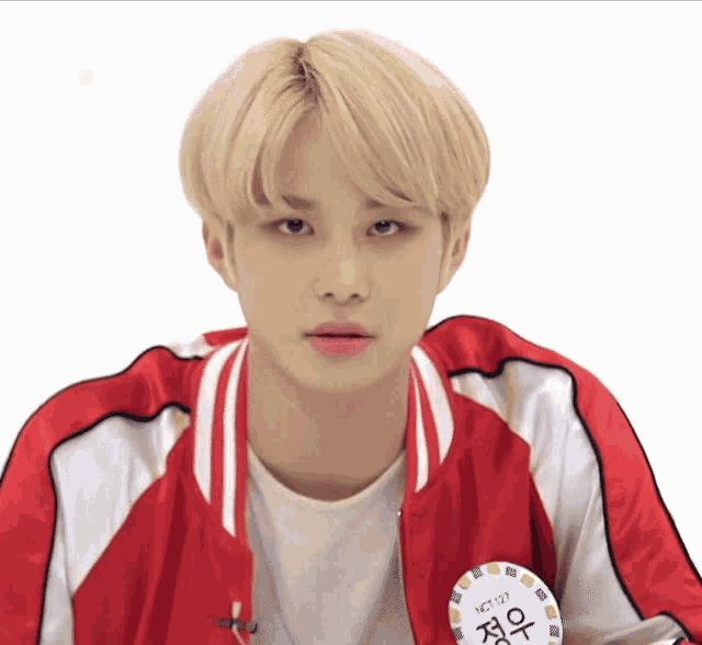 a young man wearing a red jacket with nct 127 written on it