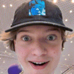 a close up of a person wearing a baseball cap with a blue logo on it .
