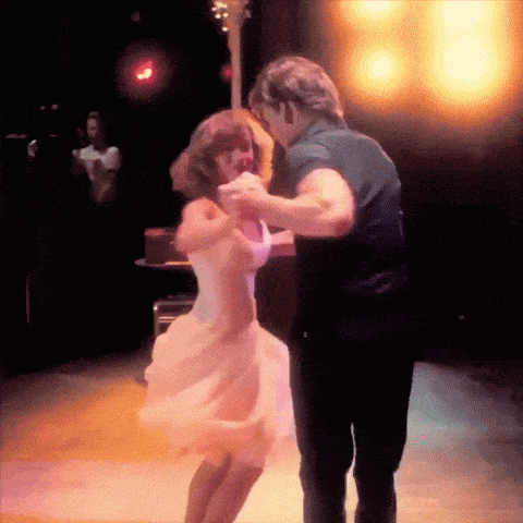 a man and a woman are dancing on a dance floor