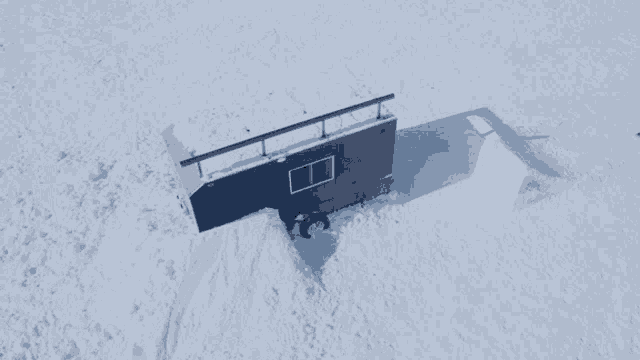 a snowboarder is doing a trick on a ramp that says red bull on it