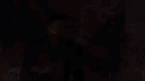 a purple object is flying through the air in a cave .