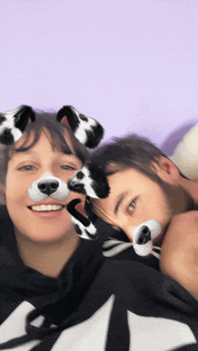 a man and a woman are posing for a picture with dog ears