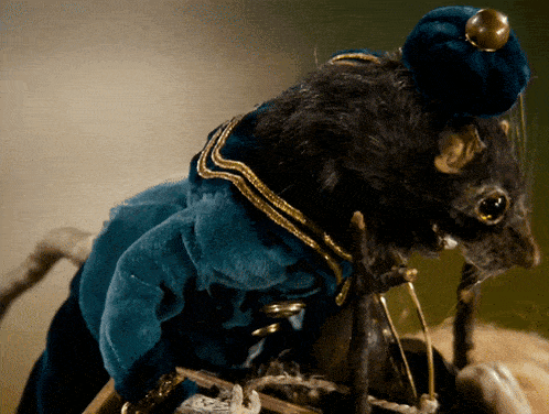 a black mouse wearing a blue jacket and a hat