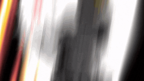 a blurred image of a person standing in a dark room with a white background