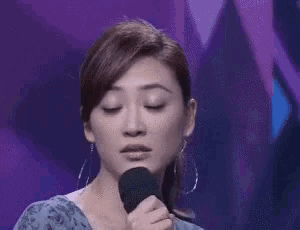 a woman is making a surprised face with her mouth wide open .