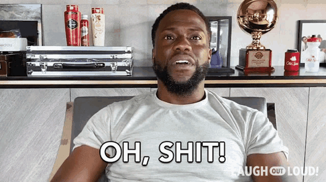 a man is sitting in a chair and says " oh shit "