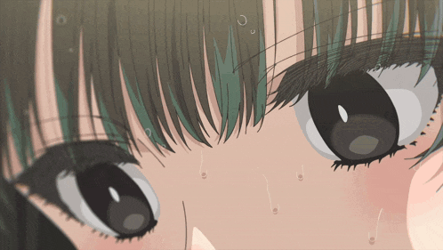 a close up of a girl 's face with a green fringe