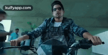 a man is riding a motorcycle in a building .
