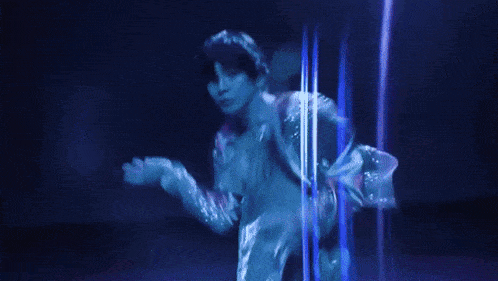 a blurry picture of a person dancing in a blue light