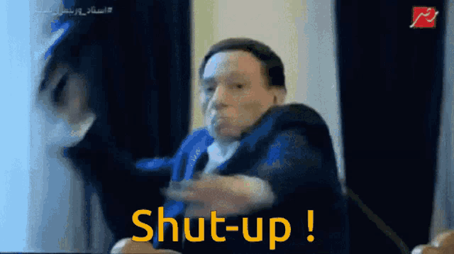a man in a suit is saying shut-up in yellow letters