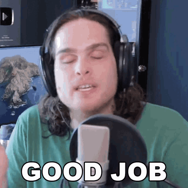 a man wearing headphones and a green shirt says good job in front of a microphone