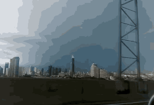 a view of a city from a highway with a cloudy sky in the background