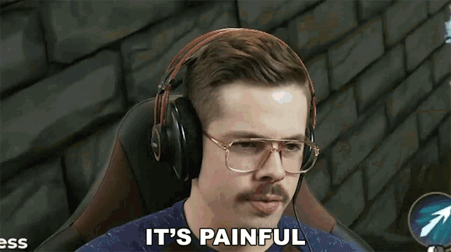 a man wearing glasses and headphones is saying it 's painful