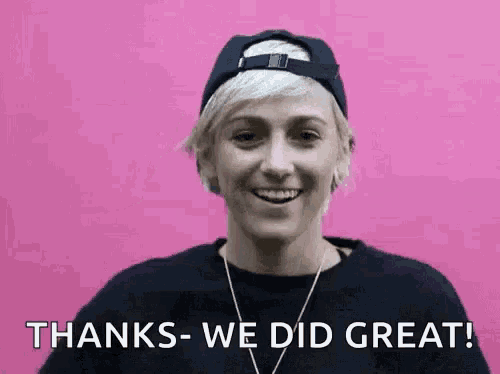 a woman wearing a baseball cap and a necklace is smiling and says `` thanks - we did great ! ''