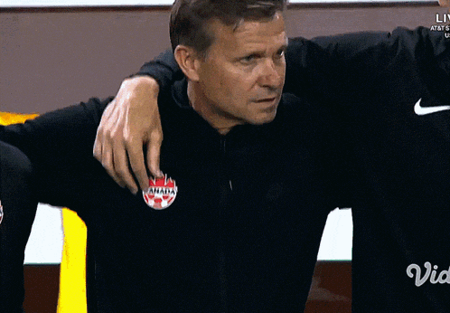 a man wearing a black nike shirt with a red bulls logo on it