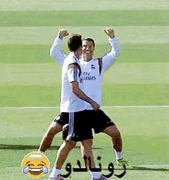 a soccer player wearing a fly emirates jersey is flexing his muscles