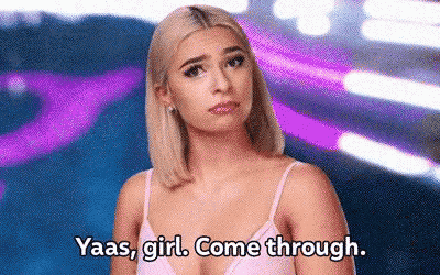 a woman in a pink tank top is talking to another woman .