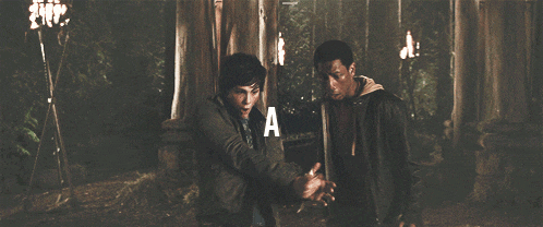 a man holding a sword with the letter a on the bottom