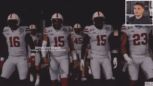 a group of football players wearing white uniforms with the number 15 on them