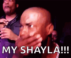a bald man is covering his mouth with his hands and says `` my shayla !!! '' .