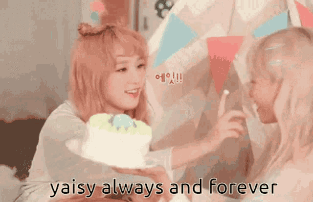 a girl holding a cake with the words yaisy always and forever written below it