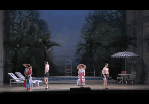 a group of people are standing in front of a pool