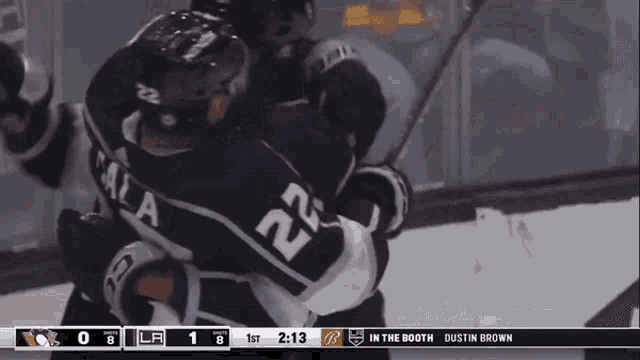 a hockey player with the number 22 on his jersey is hugging another hockey player