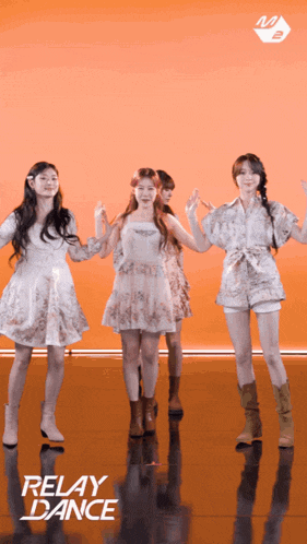 a group of girls are dancing in front of an orange background that says relay dance on it