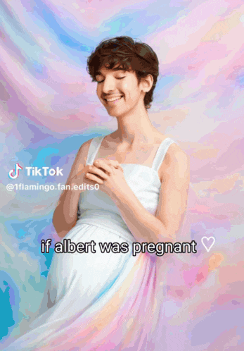 a man is wrapped in a rainbow colored cloth and has a pregnant belly