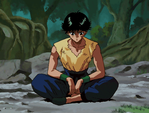 a boy in a yellow shirt sits on the ground in a forest