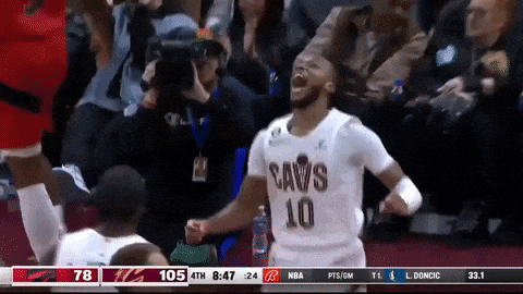 a basketball player wearing a cavs 10 jersey is celebrating