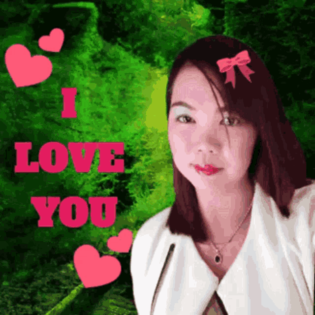 a woman with a bow in her hair stands in front of a sign that says i love you
