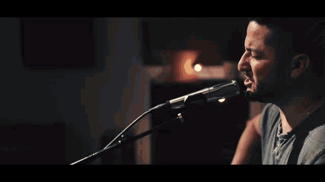 a man is playing an acoustic guitar with a yamaha logo on the headstock