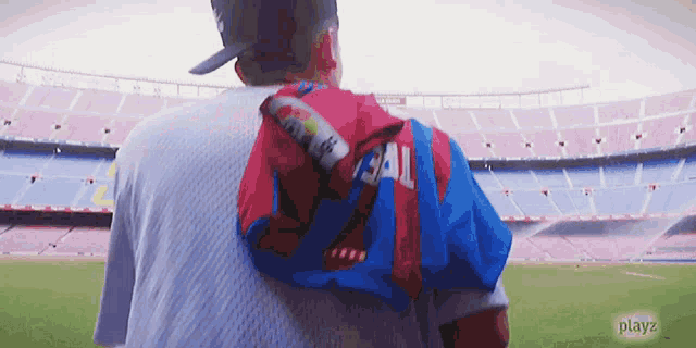 a man carrying a child wearing a shirt with the number 34 on the back