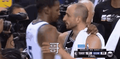 two basketball players are hugging each other during a basketball game .