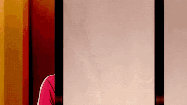 a person in a pink shirt is peeking out from behind a wall .