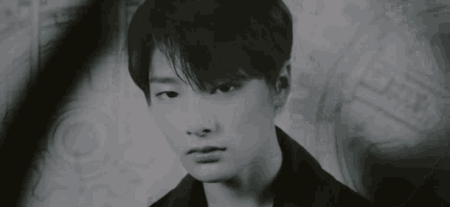 a black and white photo of a young man 's face