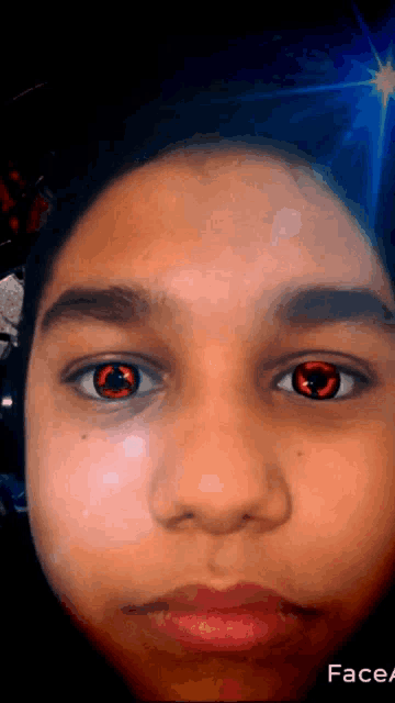a close up of a person 's face with red eyes and the word face on the bottom right
