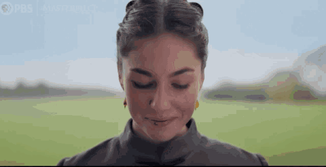 a close up of a woman 's face with the words pbs masterpiece on the bottom right
