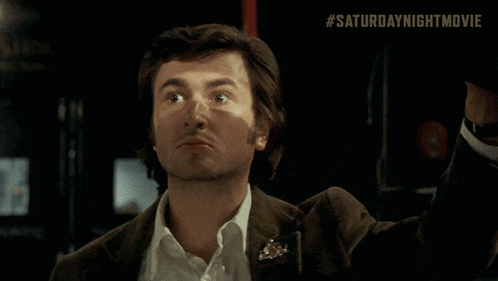 a close up of a man 's face with # saturdaynightmovie written below it