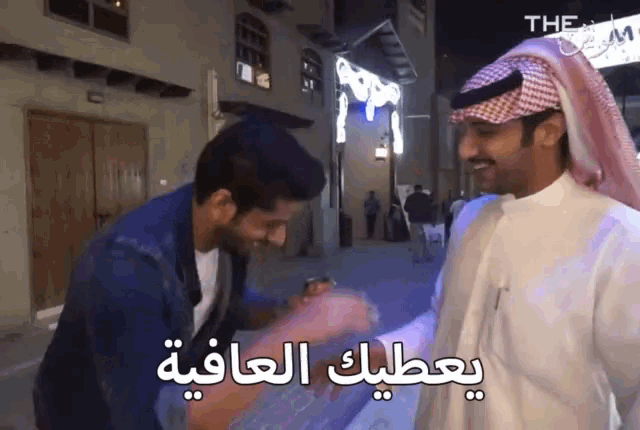 a man in a turban is talking to another man in a foreign language