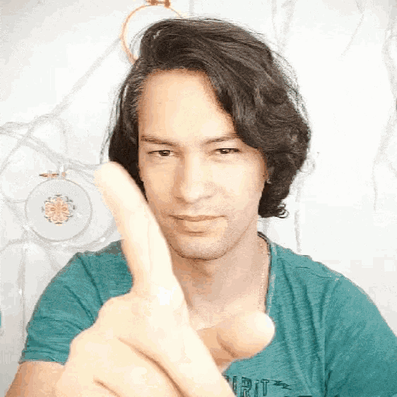 a man wearing a shirt that says spirit is pointing his finger